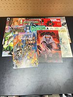 Overhead view of all ten comics fanned out on table