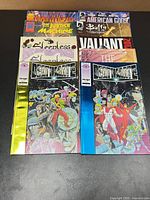 All ten comics fanned out showing covers including Deathmate variants, Buffy, American Gods, Valiant 2012, Sleepless and others