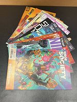 Stack of all ten comics fanned out; several titles visible