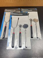 Three blister-packaged Project Pro telescoping tool kits on tabletop