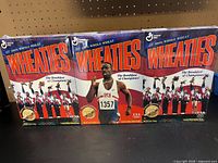 Front view of all three sealed Wheaties boxes side by side