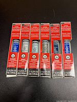 Front view of six boxed Motorcraft touch-up paint bottles