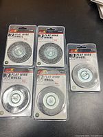 Five sealed Performance Tool 3" flat wire wheels displayed on surface