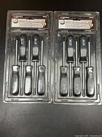 Both sealed 5-piece screwdriver sets side by side in original packaging
