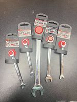 Front view of all five ratcheting combination wrenches in retail packaging