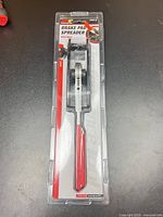 Front view of sealed package showing tool and model