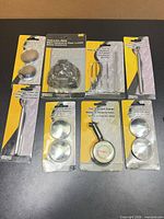Group shot of eight sealed Project Pro automotive accessories in blister packs