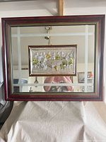 Full view of rectangular mirror with framed silver plaque