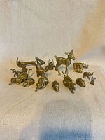 Group shot of all 18 brass miniatures on neutral background
