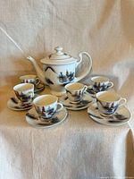 Full view showing teapot, five cup-saucer sets