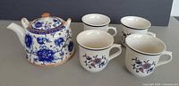 Group shot showing teapot with lid and four matching mugs