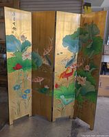 Full view of four-panel screen showing gold lacquer front with koi and lotus painting