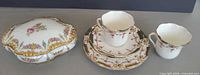 Group view: trinket box, teacups, saucers, plates