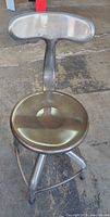 Full view of stool showing backrest, seat, and base