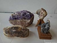 Group shot of four mineral specimens including stands