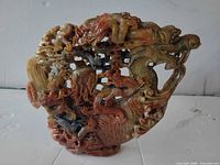 Front view of multicolored soapstone dragon carving