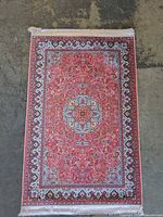 Full view of rug showing complete design, colors and fringe