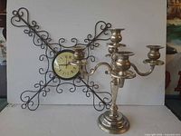 Wall clock and candelabra full view