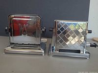 Front view of both chrome toasters side by side