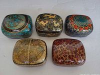 Five closed boxes showing varied hand-painted designs