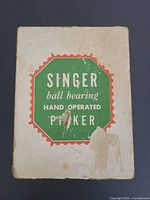 Front of original Singer pucker box showing label and wear