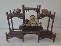 front view of display shelf with soapstone figures arranged