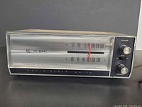 Front view showing dial, brand logo, control knobs and condition