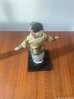 Full view of doll from above showing costume and base