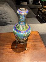 Full view of cloisonné vase on metal stand