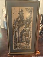 Full view of framed architectural print on easel