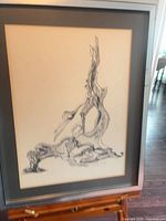 Full view of framed ink drawing showing artwork, matting, and frame