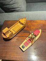 Two wooden model boats on table top