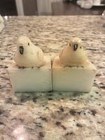 Front view of both alabaster bird bookends on granite surface