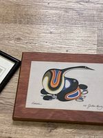 Angled view of framed Jackson Beardy print showing signature and title