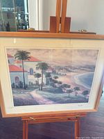 Full view of framed lithograph on easel