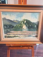 Full view of framed Kay Vines oil painting on easel