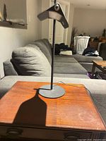 Side view of metal table lamp on wooden table