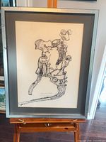 Full view of framed abstract ink drawing on easel