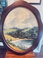 Full view of framed oval oil painting