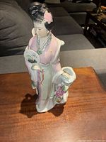Front view of porcelain geisha figurine