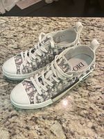 Top view of both sneakers showing monogram pattern and laces