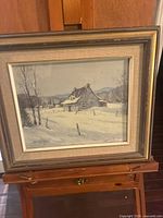 Front view of framed winter landscape painting