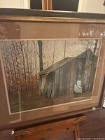 Front view of framed print under glass showing shed scene