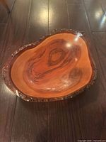 Top view of live-edge solid wood bowl showing grain and varnish