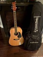 Full view of guitar with gig bag