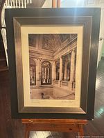 Full view of framed print on easel showing image, mat and frame