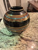 Full view of striped ceramic vase on countertop