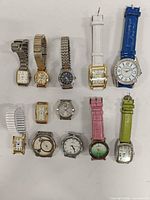 Group shot of all 12 wristwatches laid out on table