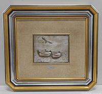 full framed artwork showing bas-relief plaque within large decorative frame