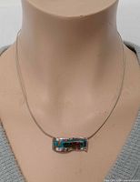 Necklace on mannequin front view showing pendant size and chain length